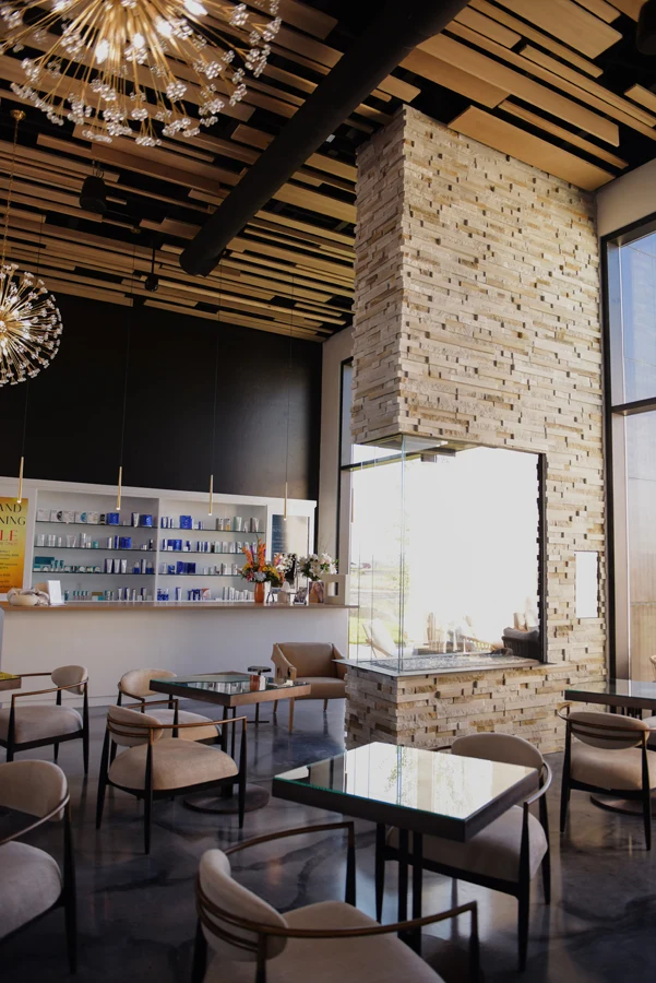Stone fireplace, timber ceiling, and lounge at Central Wellness